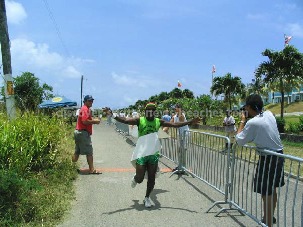 Grenadian olympic relay team member crossing the fininsh line in 2004 St Kitts Triathlon