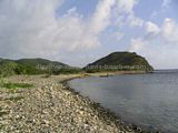 St Kitts Beaches - White House Bay showing rocky shoreline and small sandy section at southen end with Guana Point in the background.