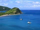 St Kitts Beaches - White House Bay showing two boats anchored in the bay and Guana Point in the background.