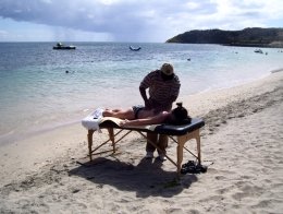 St Kitts tours and Island Safaris with Captain Sunshine Tours. St Kitts photo of Captain Sunshine Tours St Kitts massage on the beach with St Kitts masseur Kenny 'Captain Sunshine' Richardson.